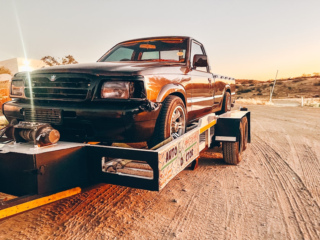 about-02 a-truck-is-being-towed-on-a-flatbed-trailer-jepqkaijobq